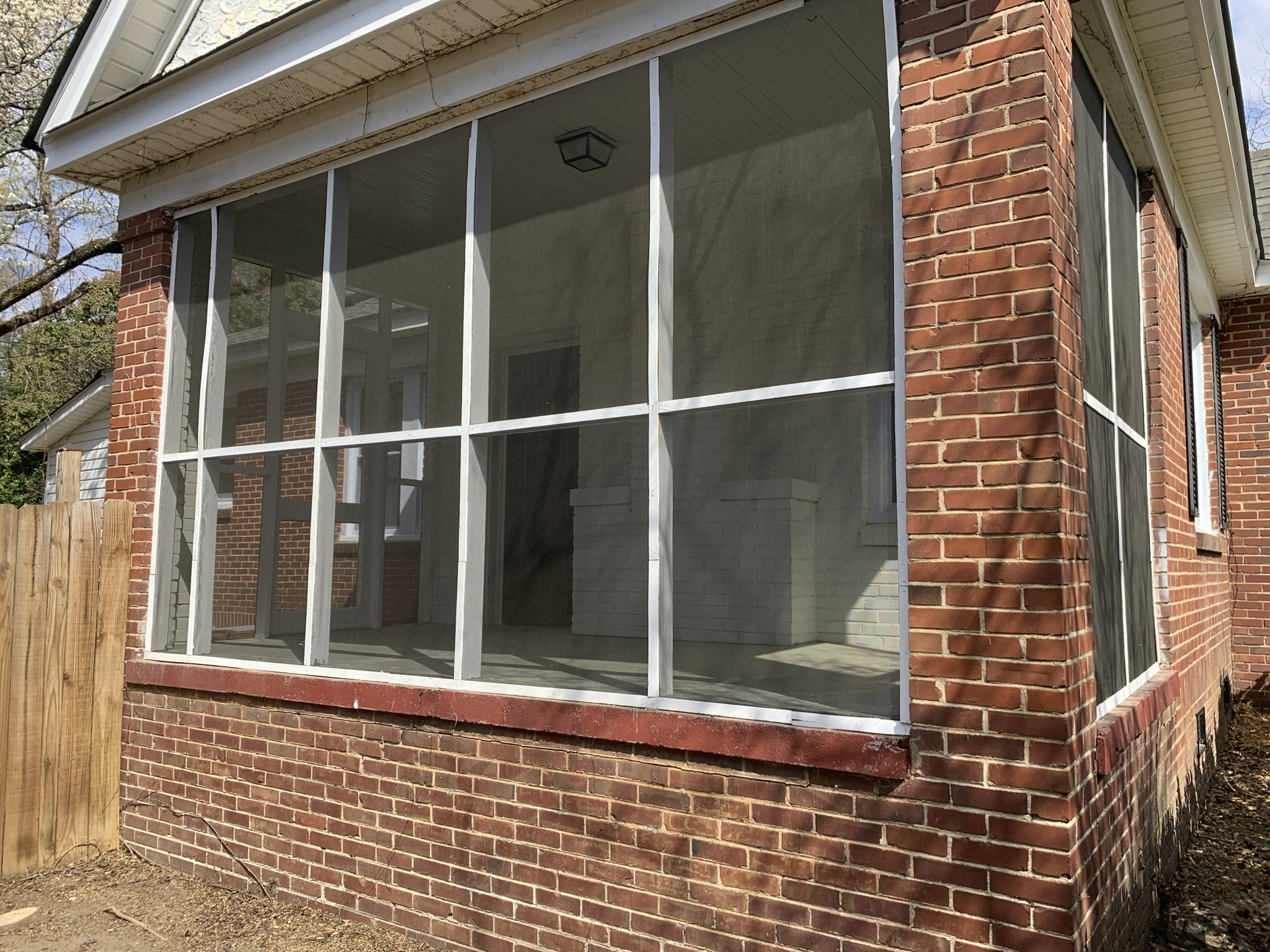 an empty window on a brick house